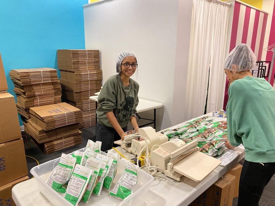 Student volunteers Ava Abraham, ’26, and Vicky Cruz, ’26, seal bags of food that will be packaged and shipped to Nicaragua.
