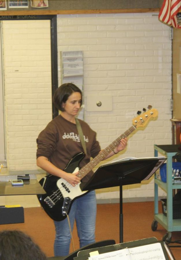 Lauren Whisnant, Orchestra and Band Director, plays the electric bass.