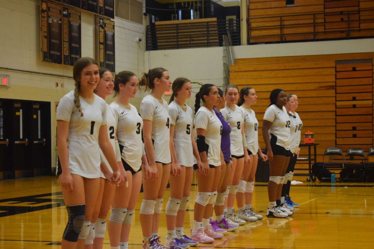 The+Varsity+Girls+Volleyball+team+lines+up+for+their+game+against+Bartlett.+