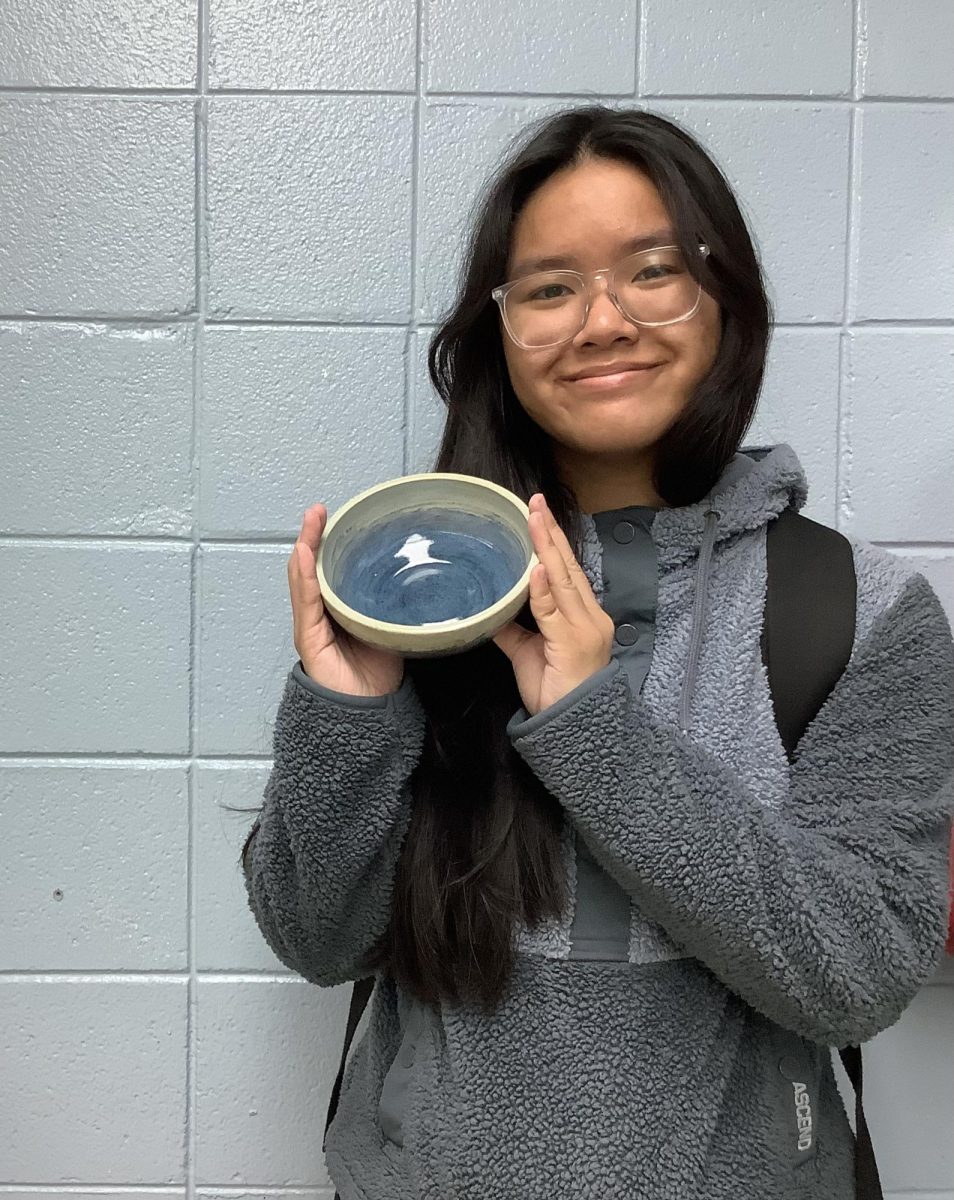 Alyssa Yim, '25, shows off her ceramic piece.